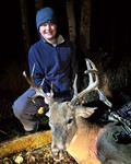 Titus with his first archery buck, Ricky.